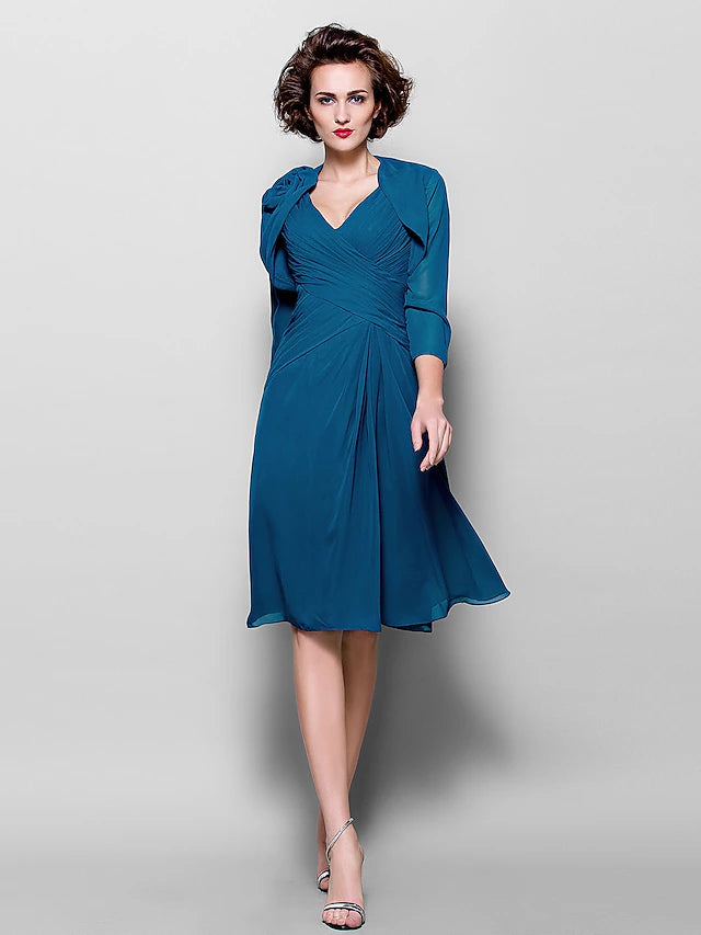 Close-up of the V-neckline and 3/4 length sleeve of the chiffon dress.