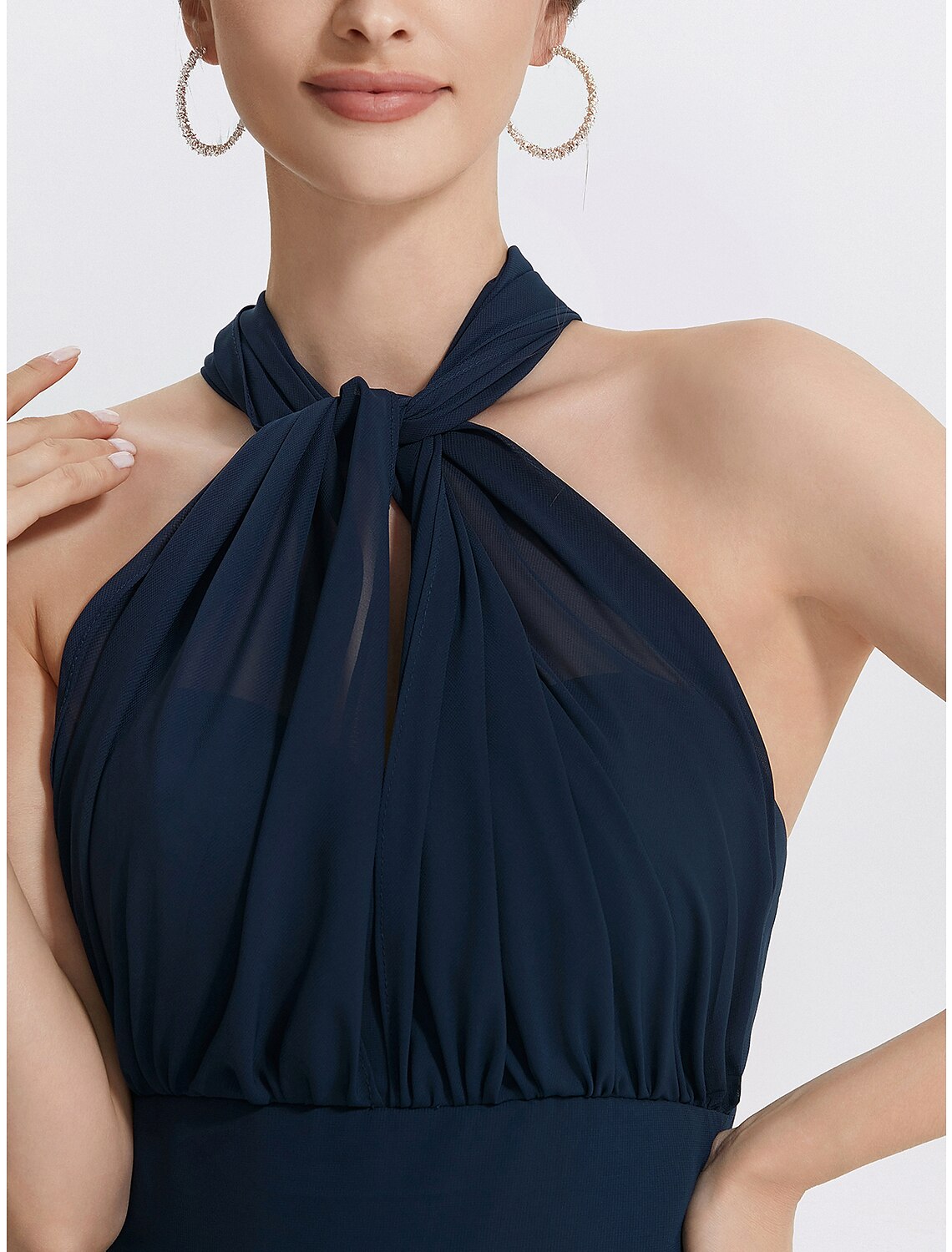 Close-up of the ruched detail on the chiffon dress.