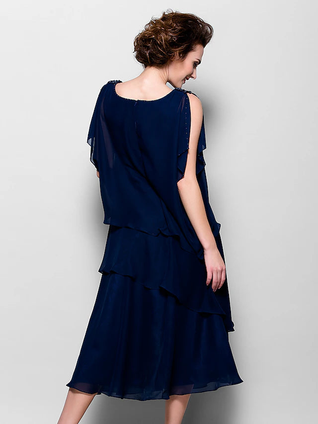 Woman posing in the tea length A-line chiffon dress, showcasing its silhouette.