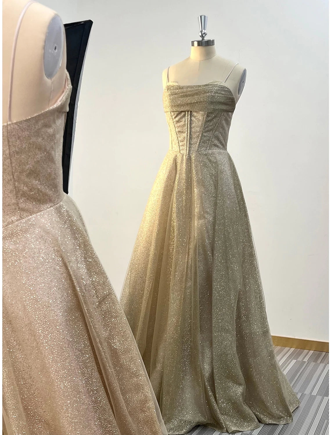 Close-up of the glitter tulle fabric and cowl neck detail on the evening gown.