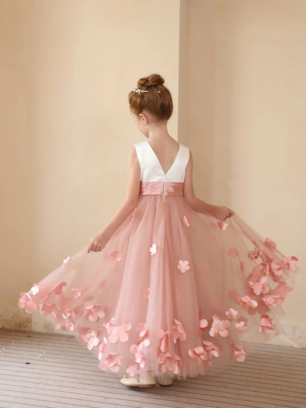 Back view of an A-line flower girl dress with delicate appliques.