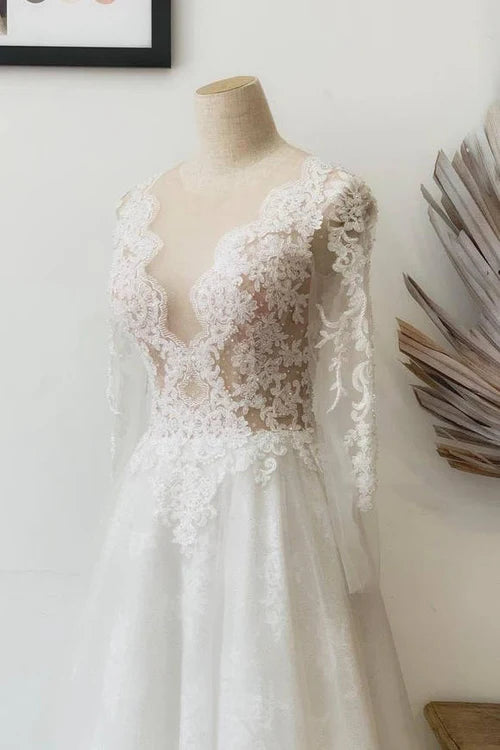 Close-up of delicate floral lace detail on a wedding dress.
