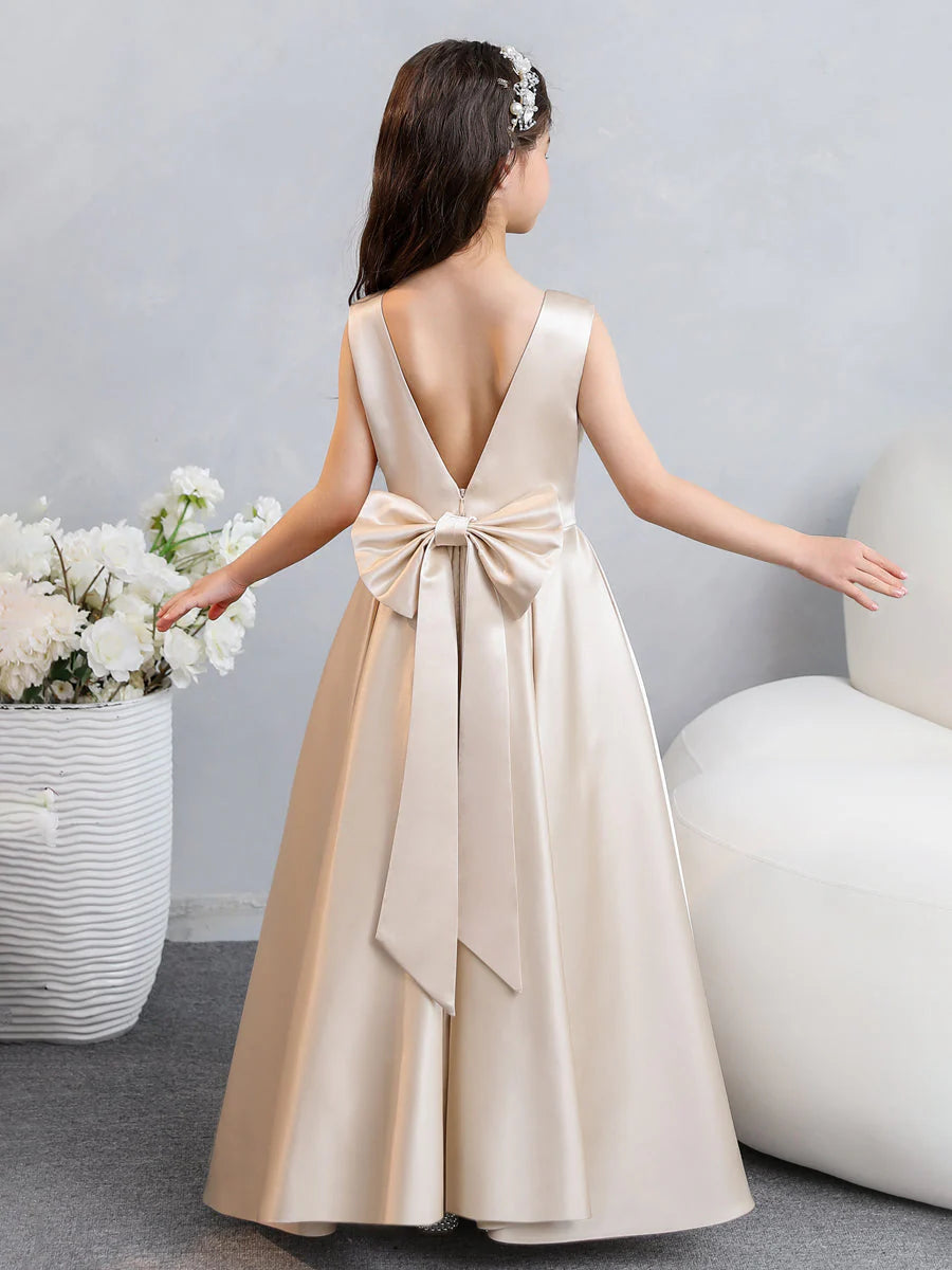 Side view of the white satin flower girl dress, showing the full A-line skirt.