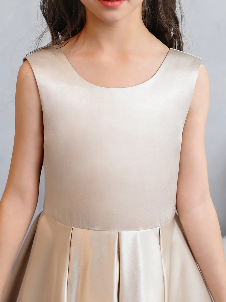 Close-up of the crew neck and bodice of the white satin flower girl dress.
