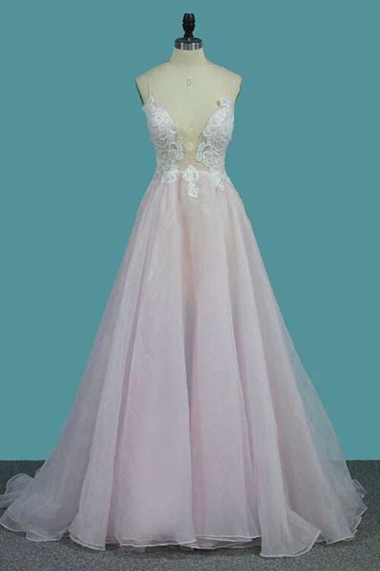 Elegant A-line prom dress with deep V-neck, spaghetti straps, and delicate appliques.