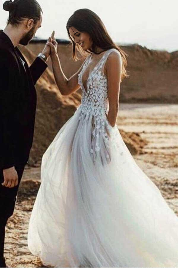 Elegant A-Line Deep V-Neck Tulle Wedding Dress with appliques and a split skirt.