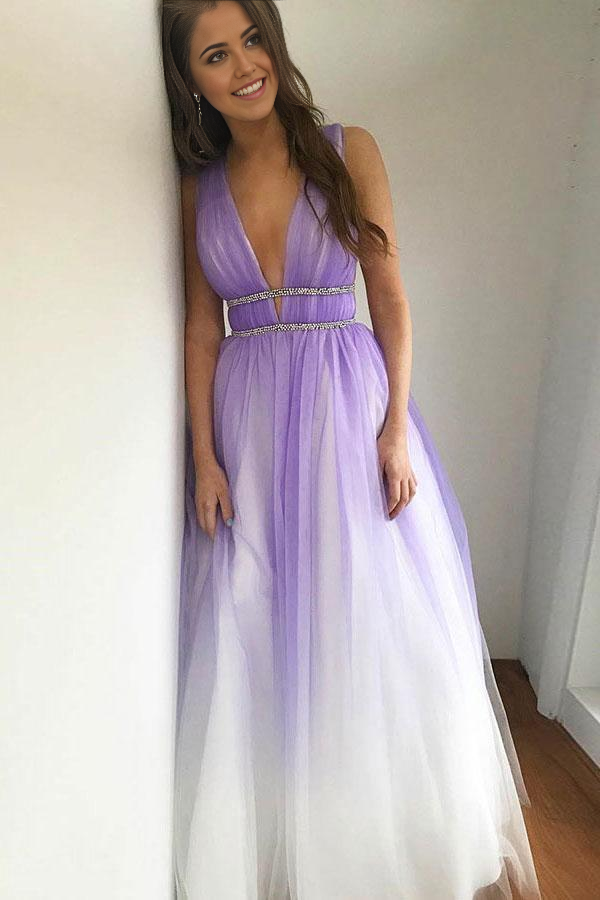 Purple A-line prom dress with deep V-neck, tulle skirt, and beaded details.