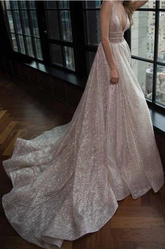 Model wearing an elegant A-line deep V-neck sequin prom dress with a court train.