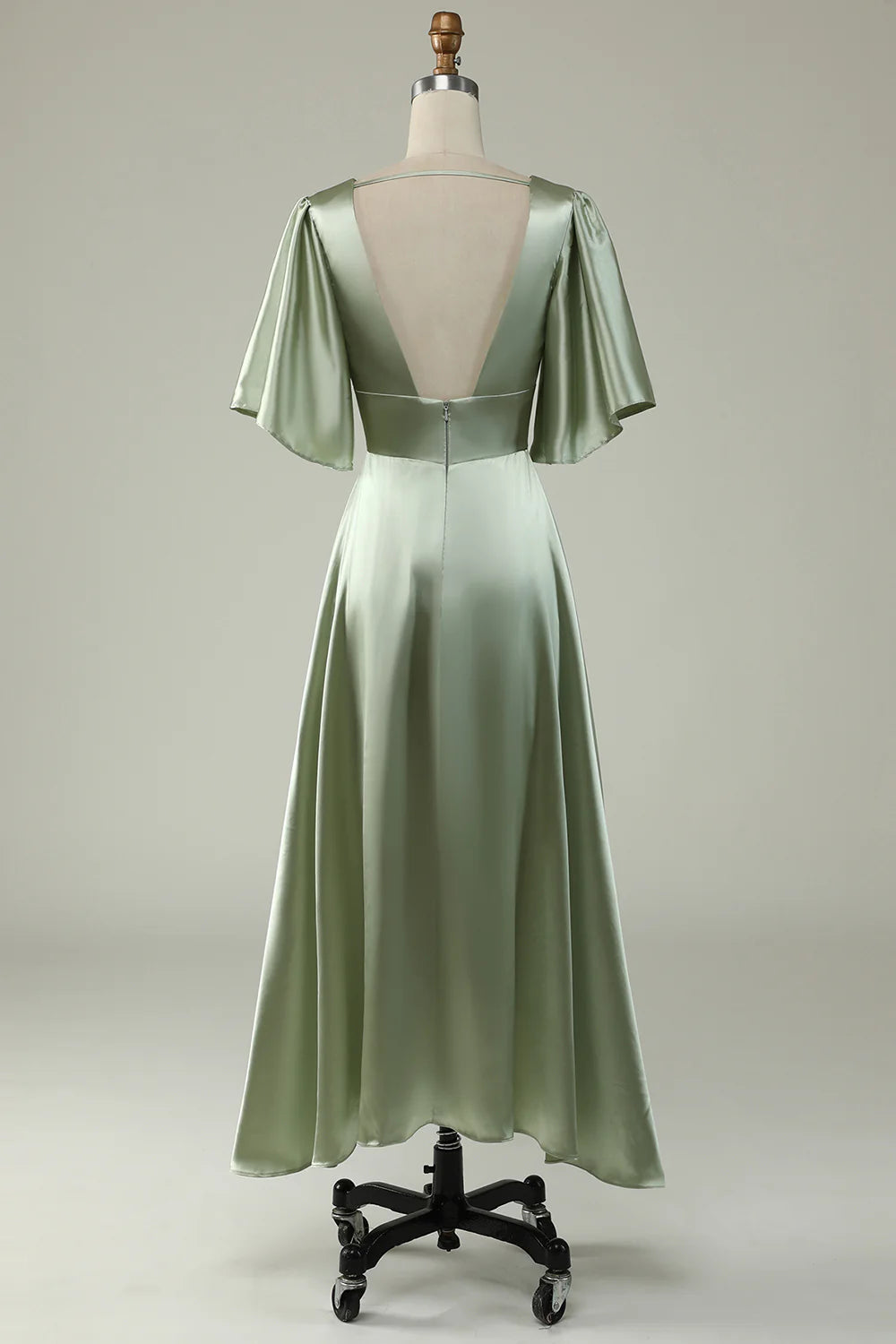 Side view of a light green satin formal gown, showcasing the flowy A-line skirt.