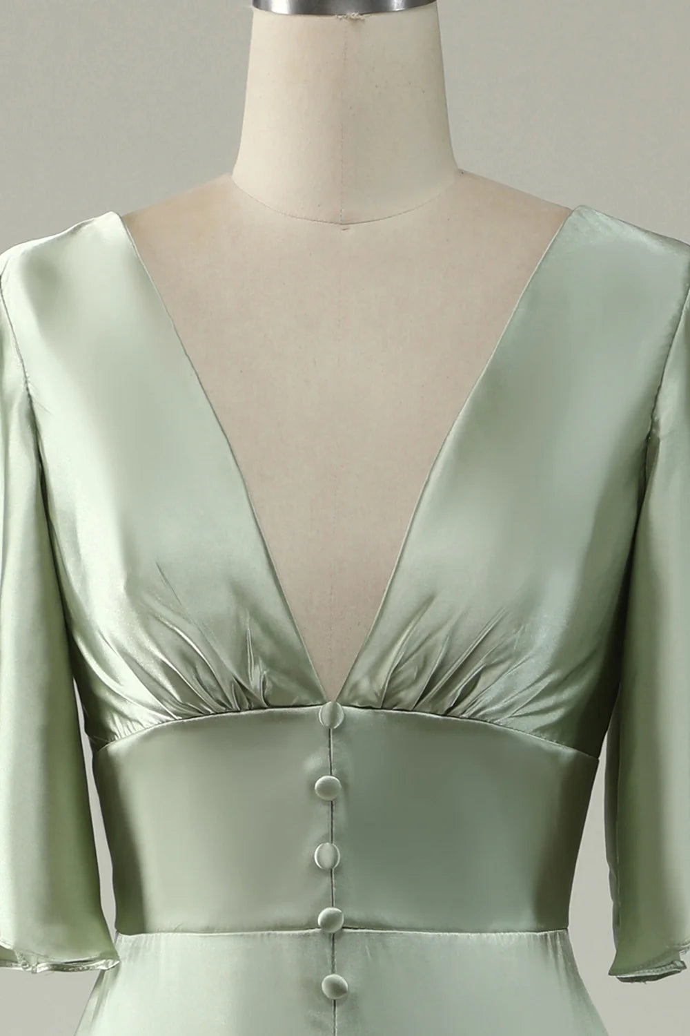 Back view of the light green satin prom dress, highlighting the button closure.