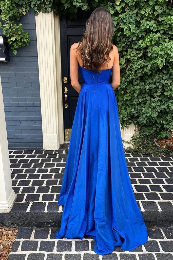 Back view of the royal blue A-line prom dress, showcasing its long flowing skirt.
