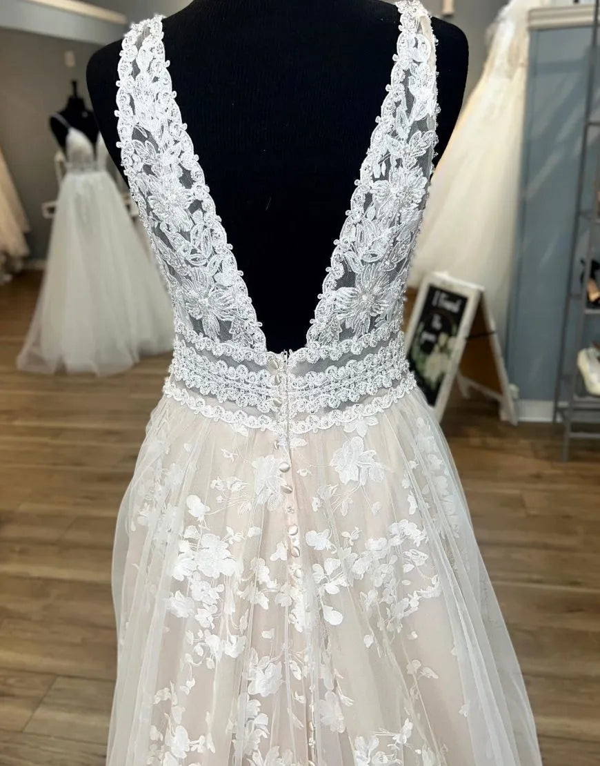 Detail of the lace appliques on a champagne plus size wedding dress.