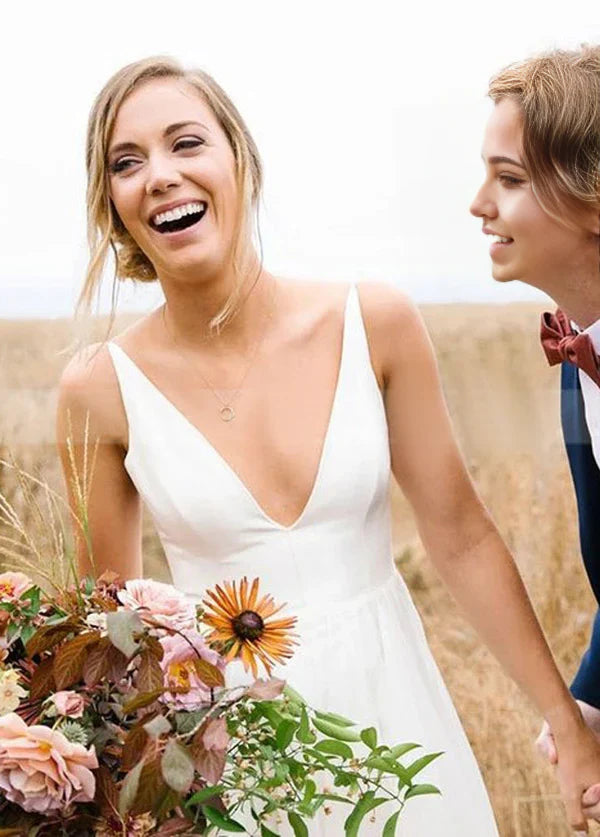 Side view of an A-line deep V-neck sleeveless chiffon long beach wedding dress on a model.