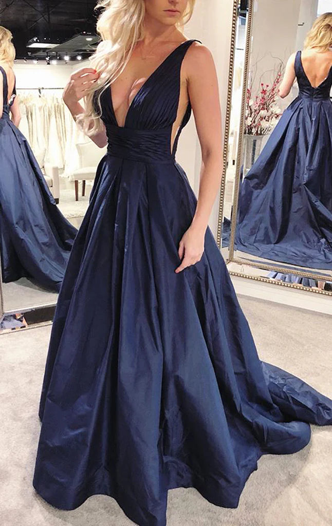 Woman wearing an elegant deep V-neck A-line prom gown.