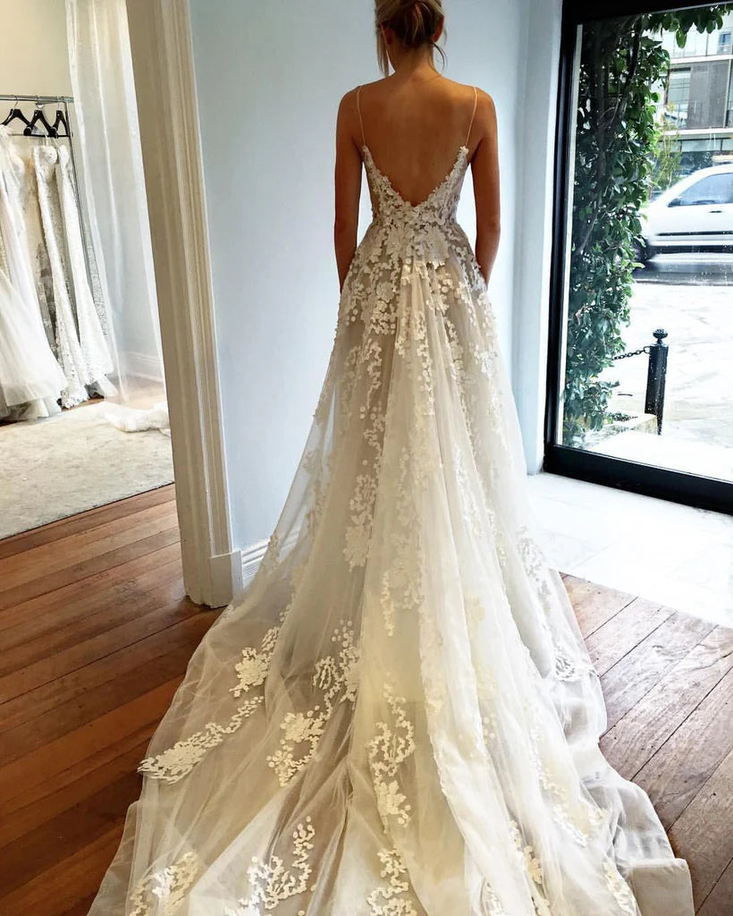 Deep V-neck spaghetti strap beach wedding gown.