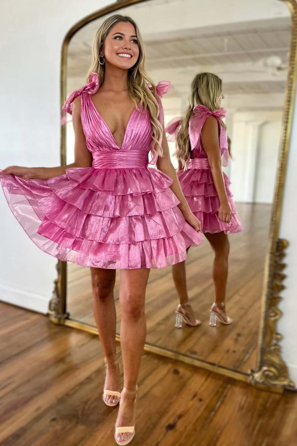 Model in an elegant A-line deep V-neck short satin dress, front view.