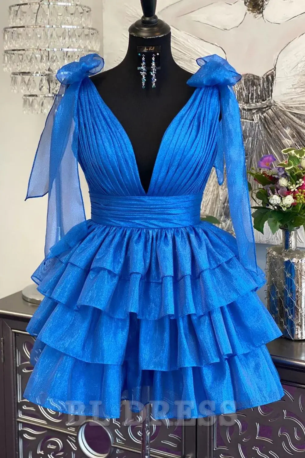 Model in an elegant A-line deep V-neck short satin dress, back view.