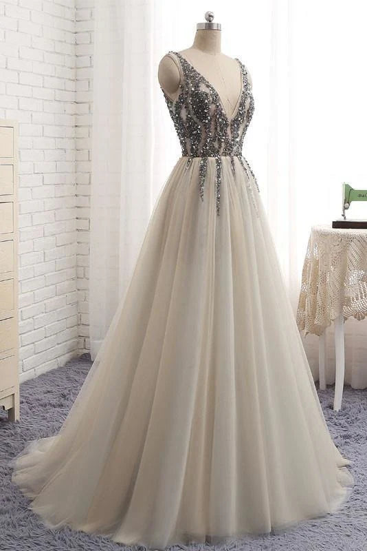 Sparkling tulle prom dress featuring a deep V-neckline.