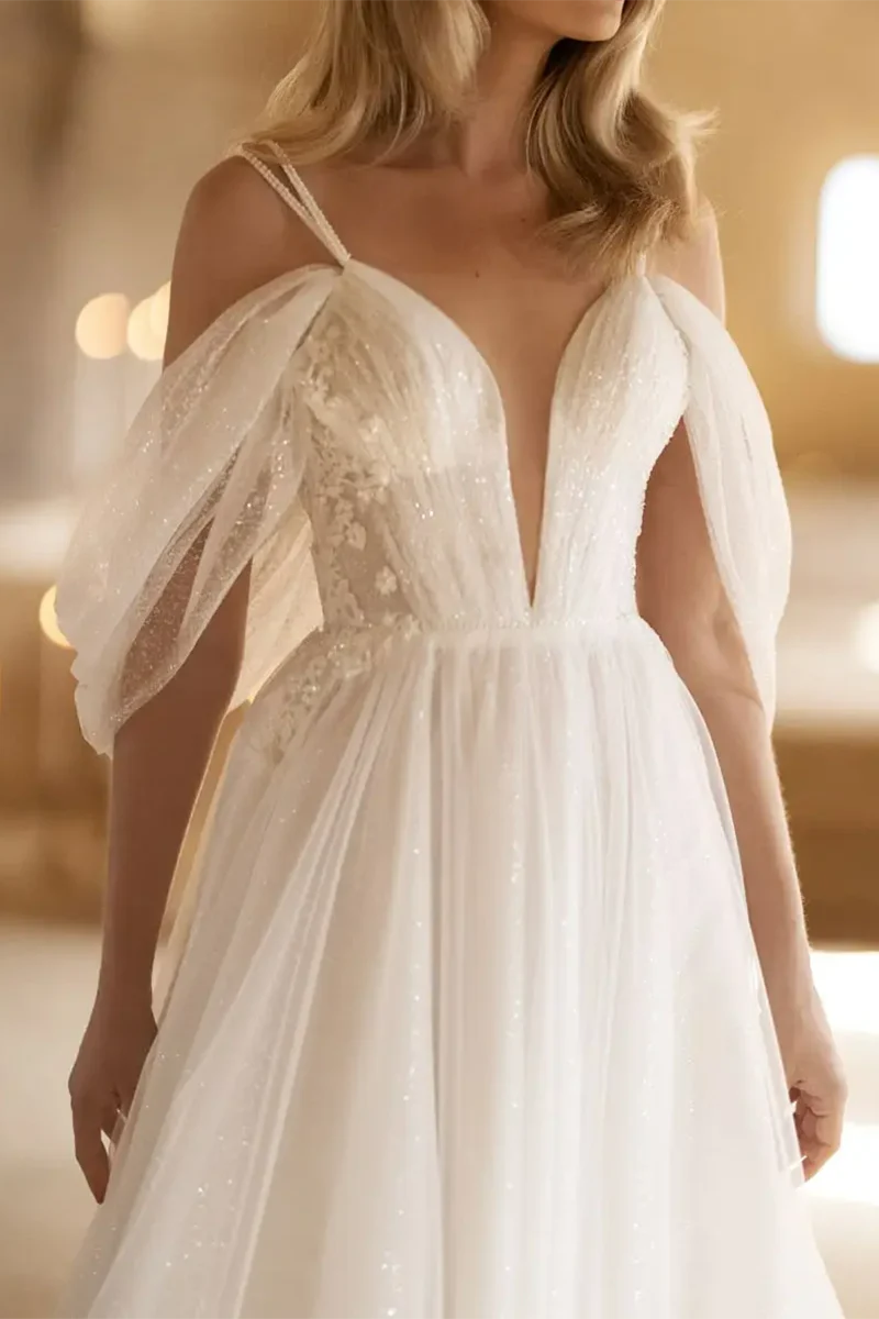 Back view of an A-line tulle wedding dress with a flowing skirt.