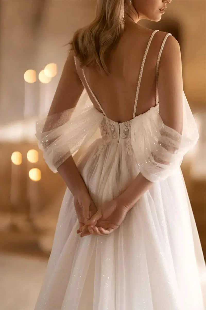 Side view of a sleeveless A-line bridal gown with a deep V-neck.