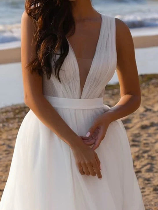 Close-up of the delicate tulle fabric and deep V-neckline of the wedding dress.