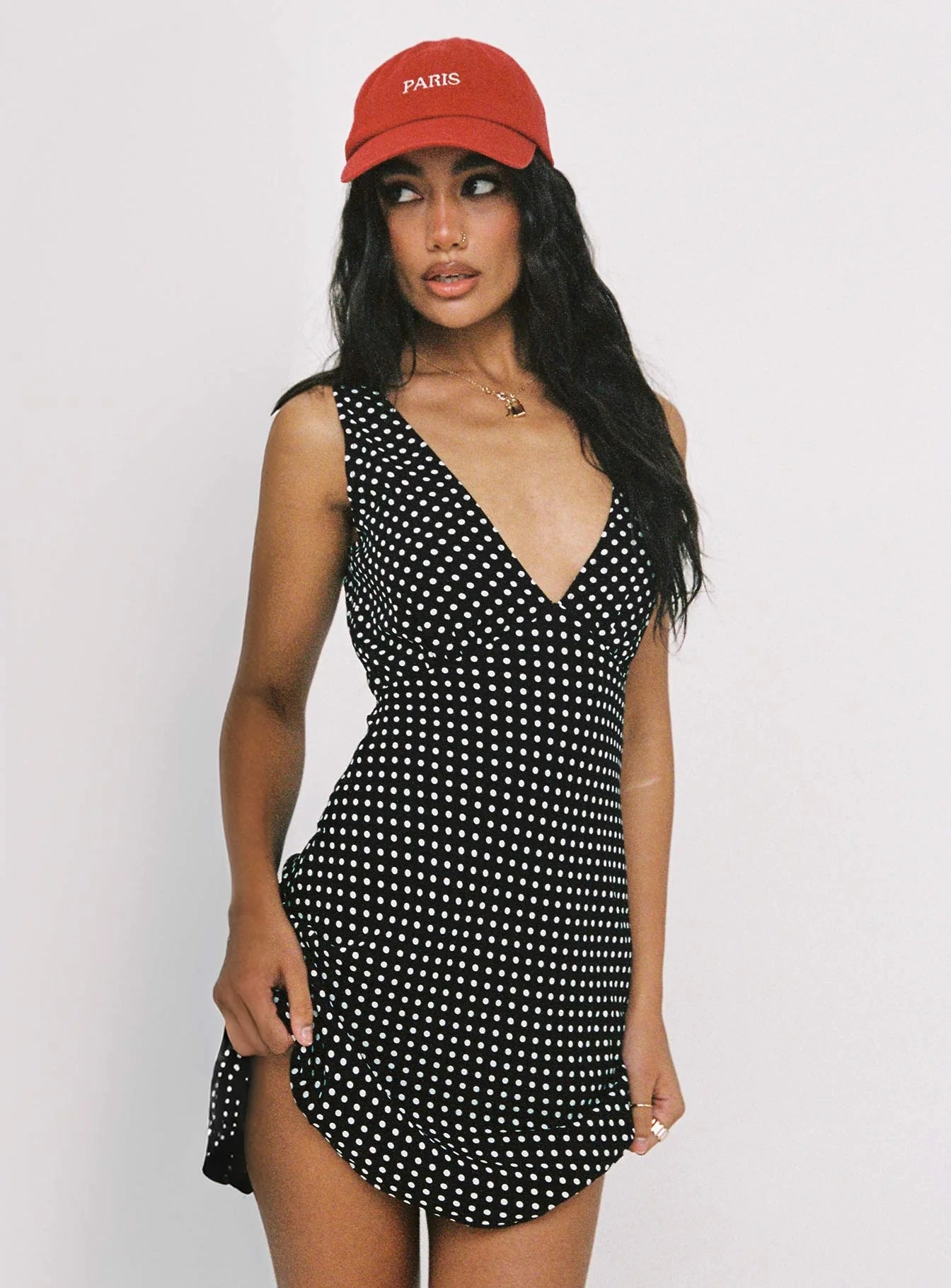 Close-up of the black and white polka dot print on the elegant mini homecoming dress fabric.