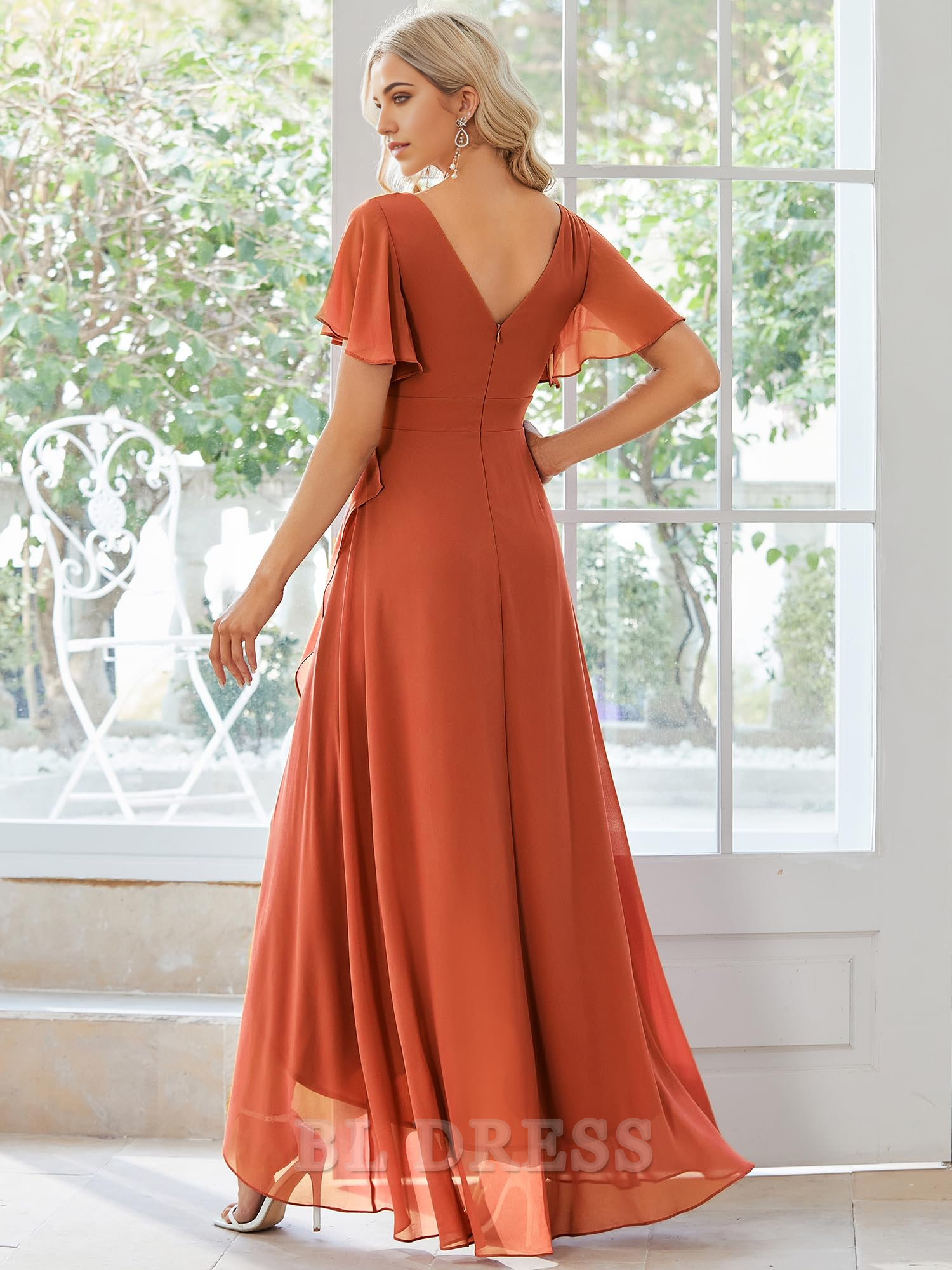 Back view of a high-low chiffon dress, showcasing the backless design.