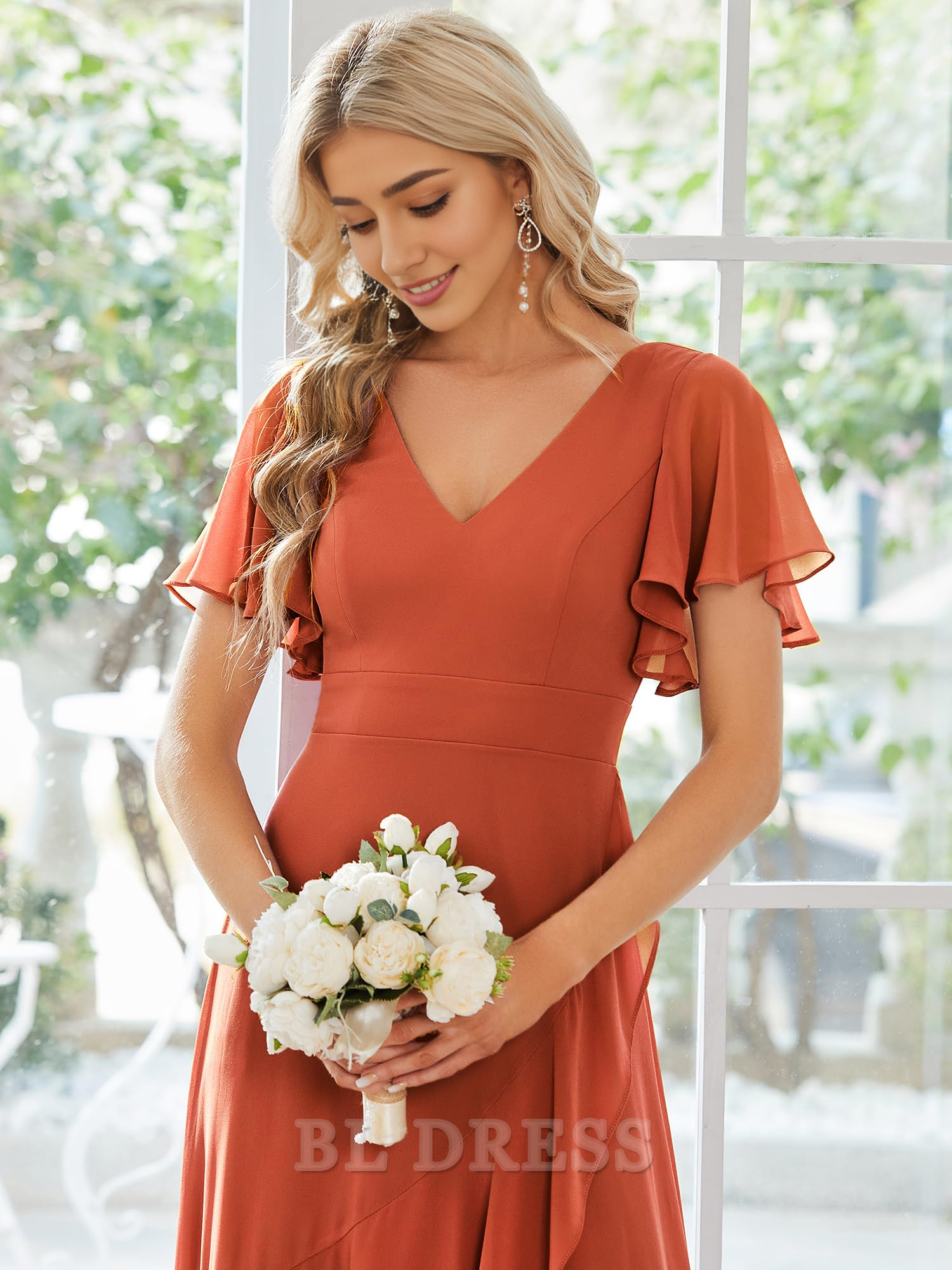 Side view of an A-line chiffon dress, highlighting the ruffle hem.