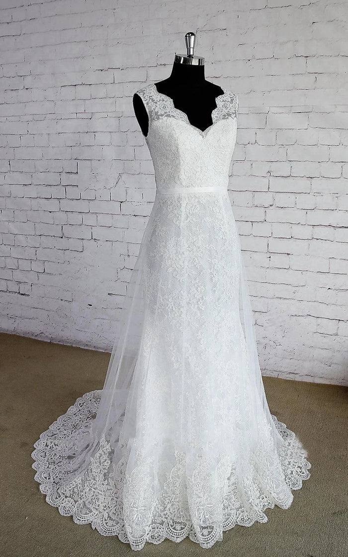 Close-up of the delicate lace detailing on a sleeveless wedding gown.