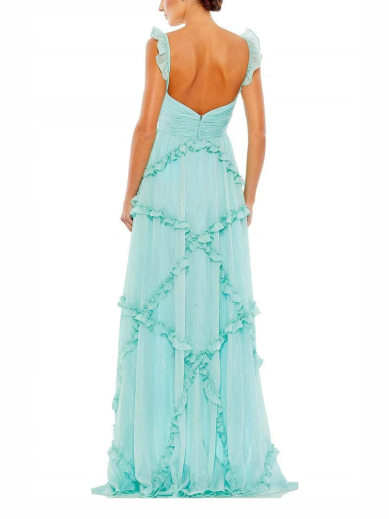 Back view of a woman in a flowing A-line spaghetti strap formal gown.