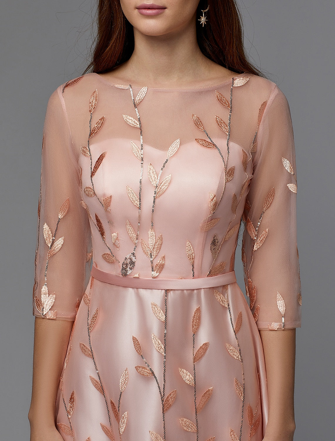 Detail of the 3/4 length sleeve and lace pattern on the formal A-Line dress.