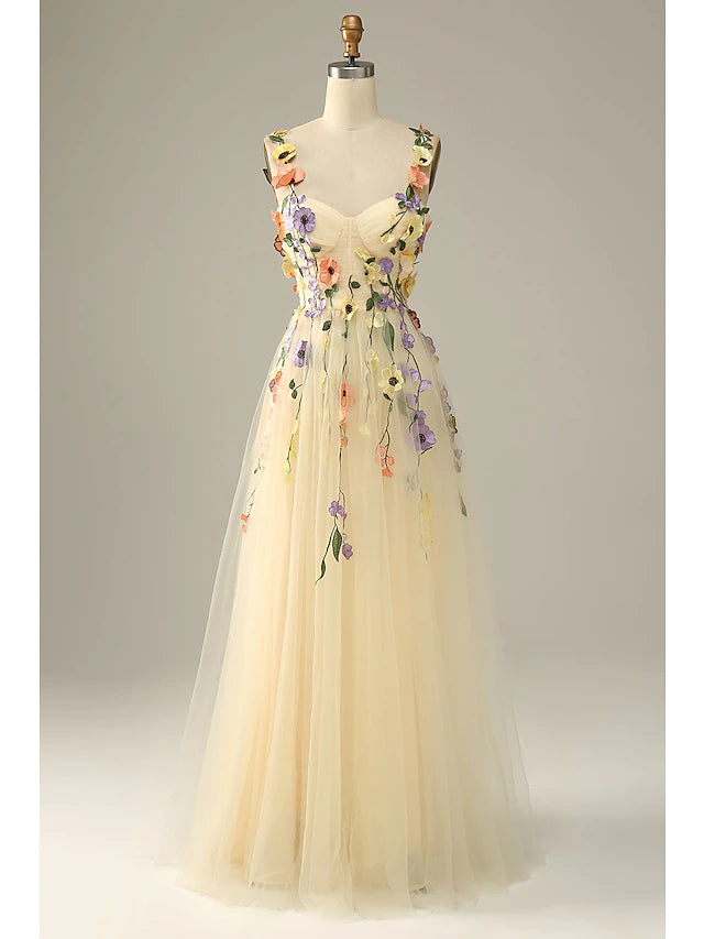 Model wearing an elegant A-line floral tulle dress with spaghetti straps.