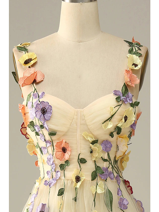 Detail of the spaghetti straps and neckline of the floral tulle dress.
