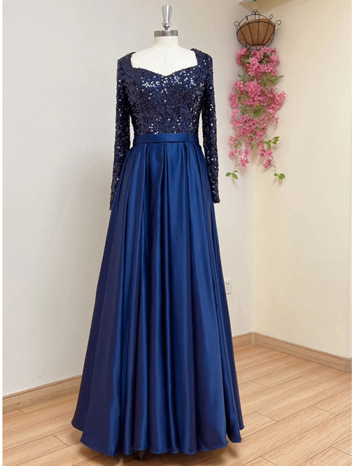 Elegant A-line satin evening gown with long sleeves and square neckline.