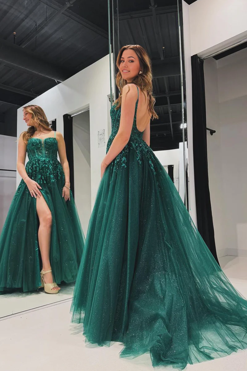 Green A-line prom dress with spaghetti straps and appliques, side view.