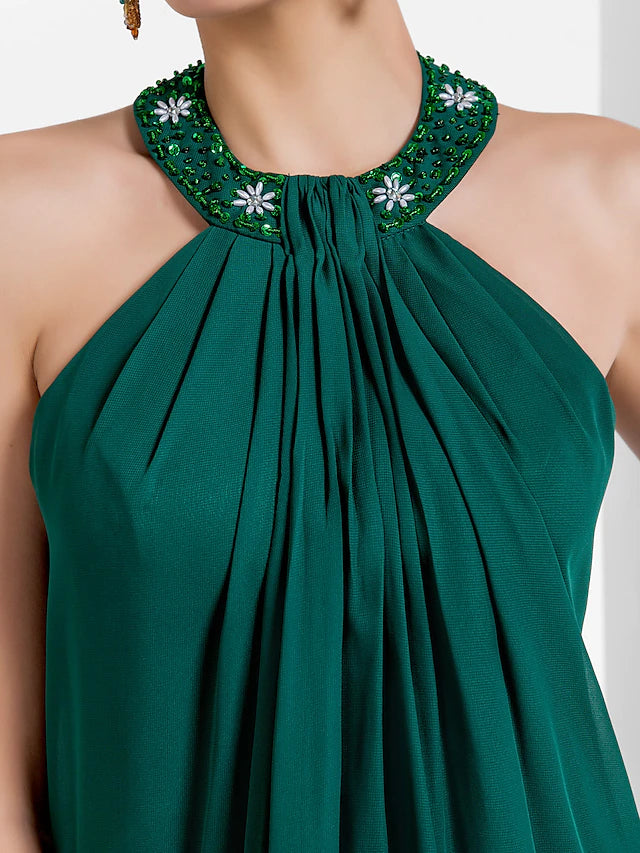 Detailed view of the flowing chiffon fabric and pleats.