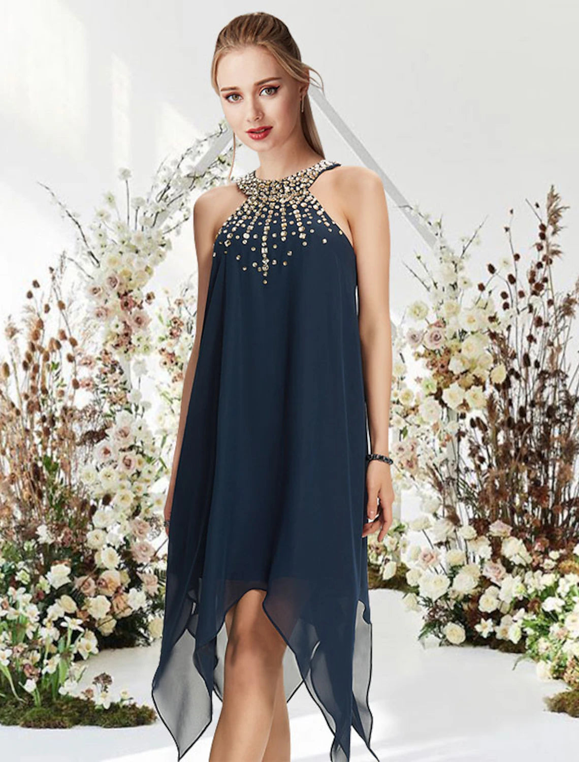 Full view of an A-line halter cocktail dress with asymmetrical hem and crystal beading.