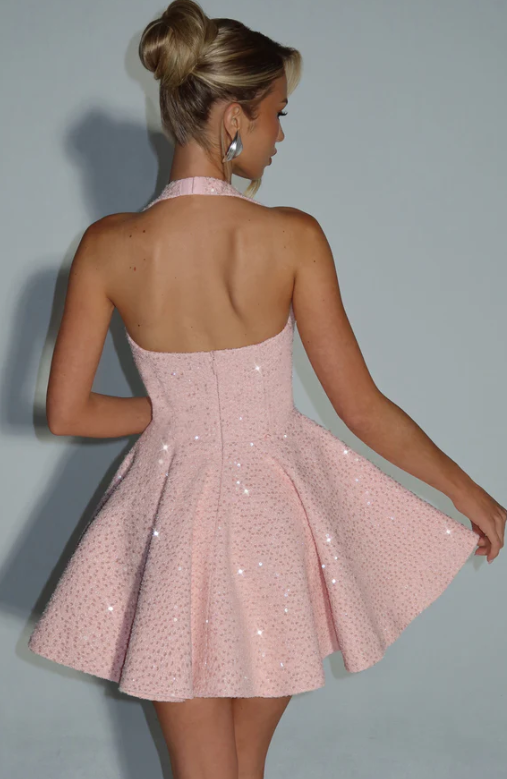 Model posing in a short A-line halter homecoming dress.