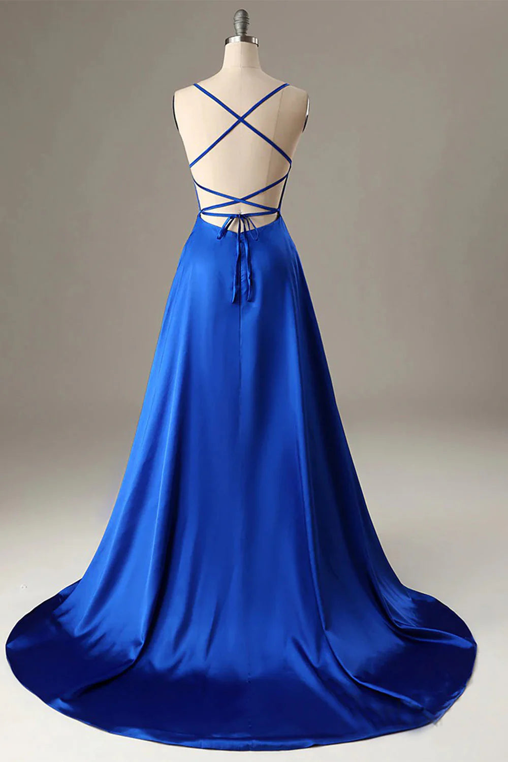Side view of a royal blue A-line halter backless formal gown.