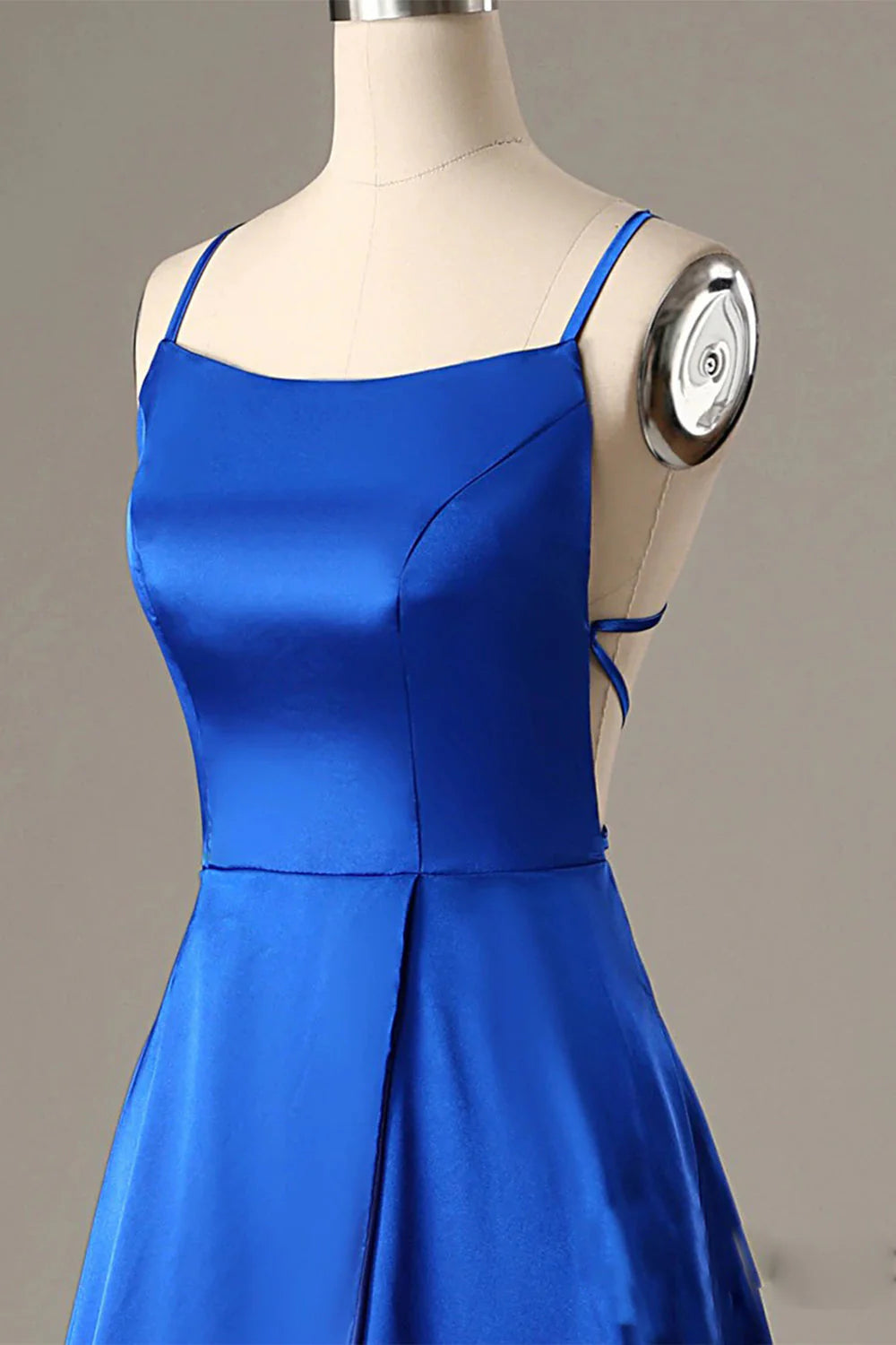 Back view of a royal blue A-line halter backless evening dress.