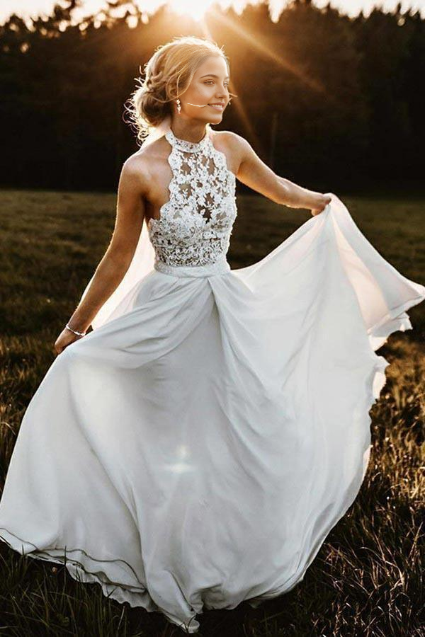 Elegant A-Line halter neck wedding dress in chiffon with lace details, ideal for a beach ceremony.