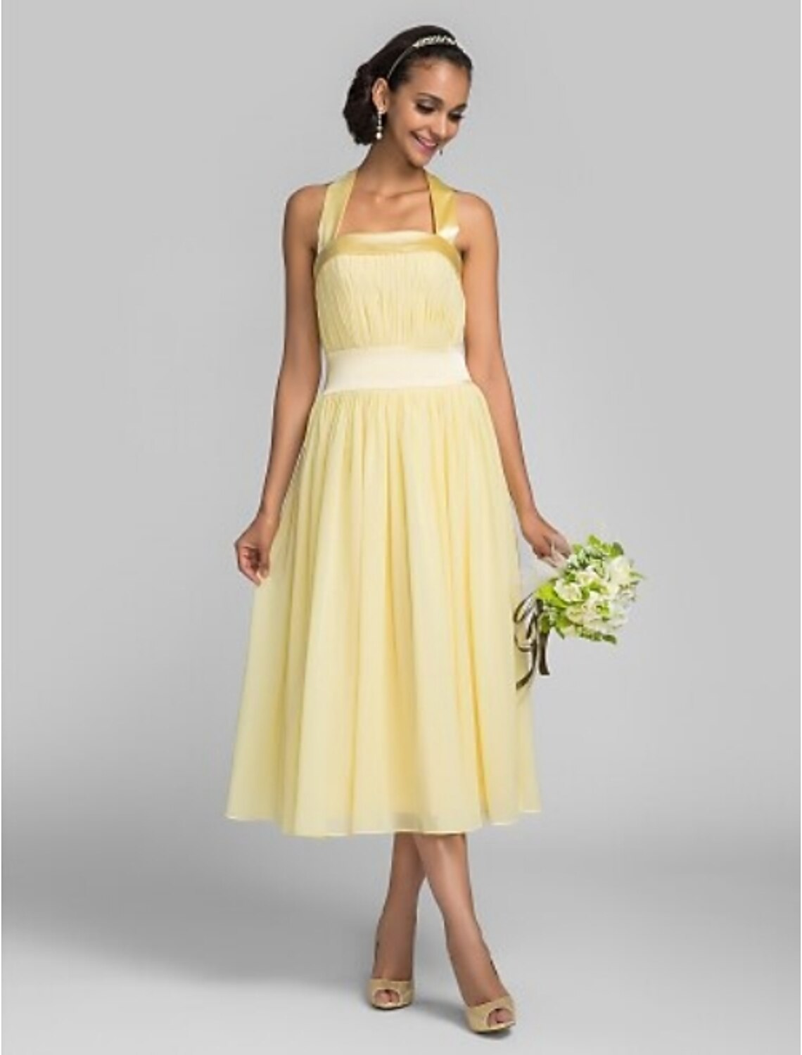 A-line halter tea length bridesmaid dress with draping on a model.