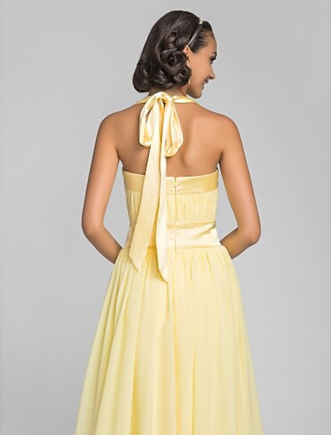 Close-up of the halter neckline and draped bodice of the dress.