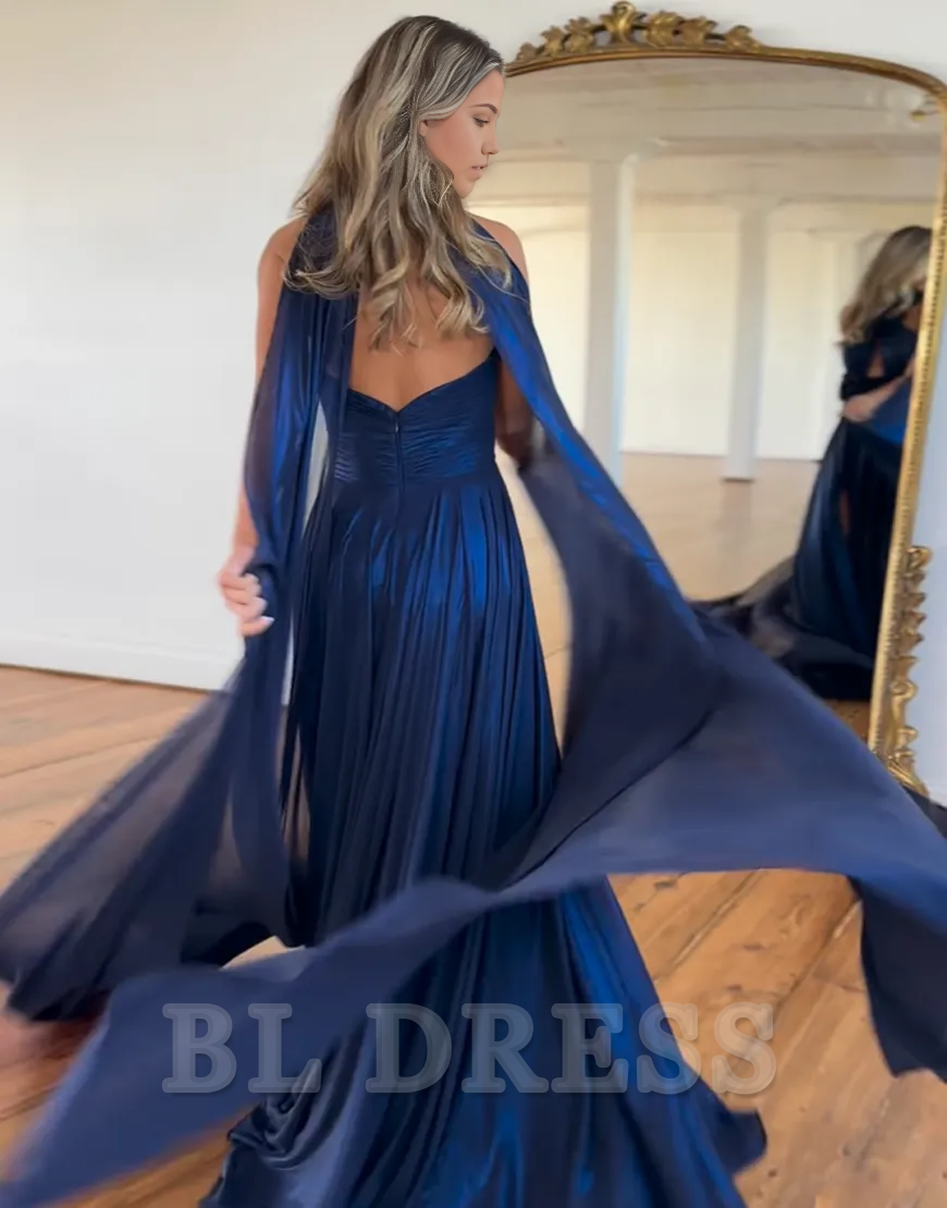 Side view of the navy A-line halter dress, highlighting the flowing skirt and elegant slit.