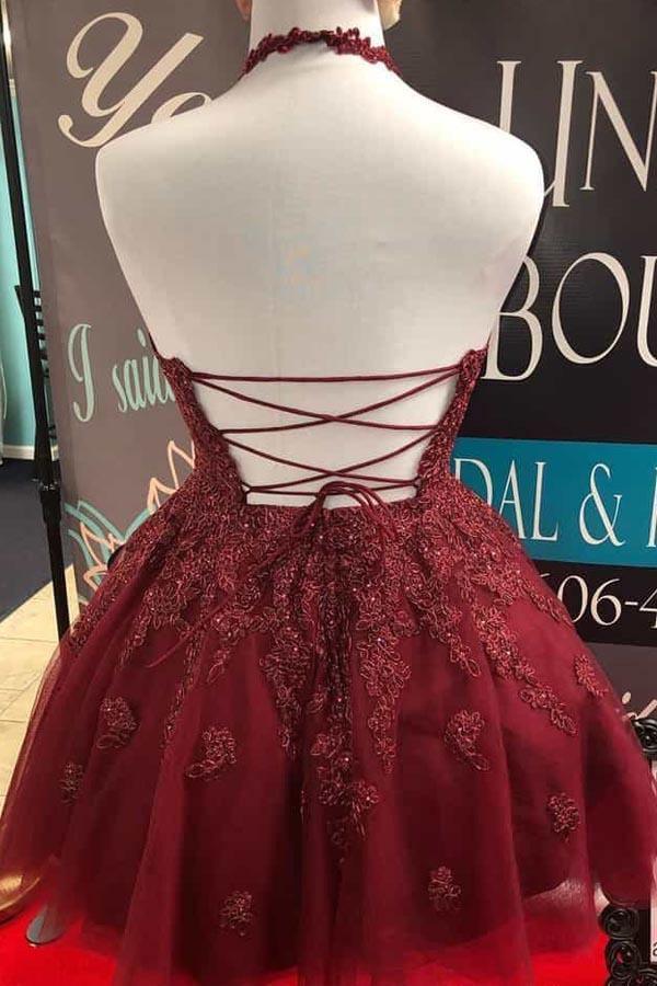 Back view of a burgundy lace A-line halter homecoming dress.