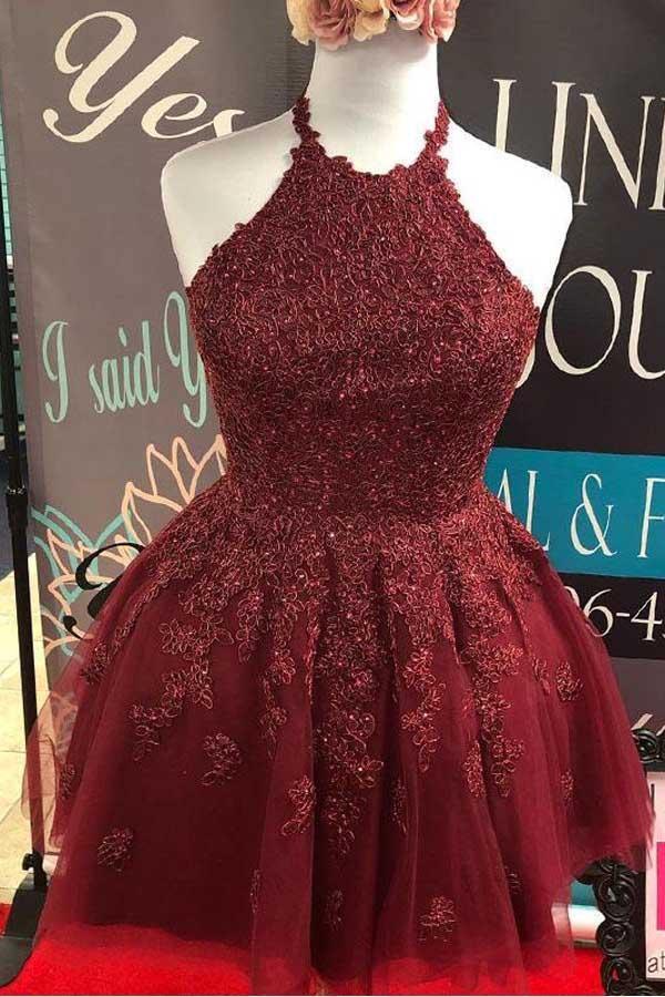 Full length view of a burgundy A-line lace halter dress.