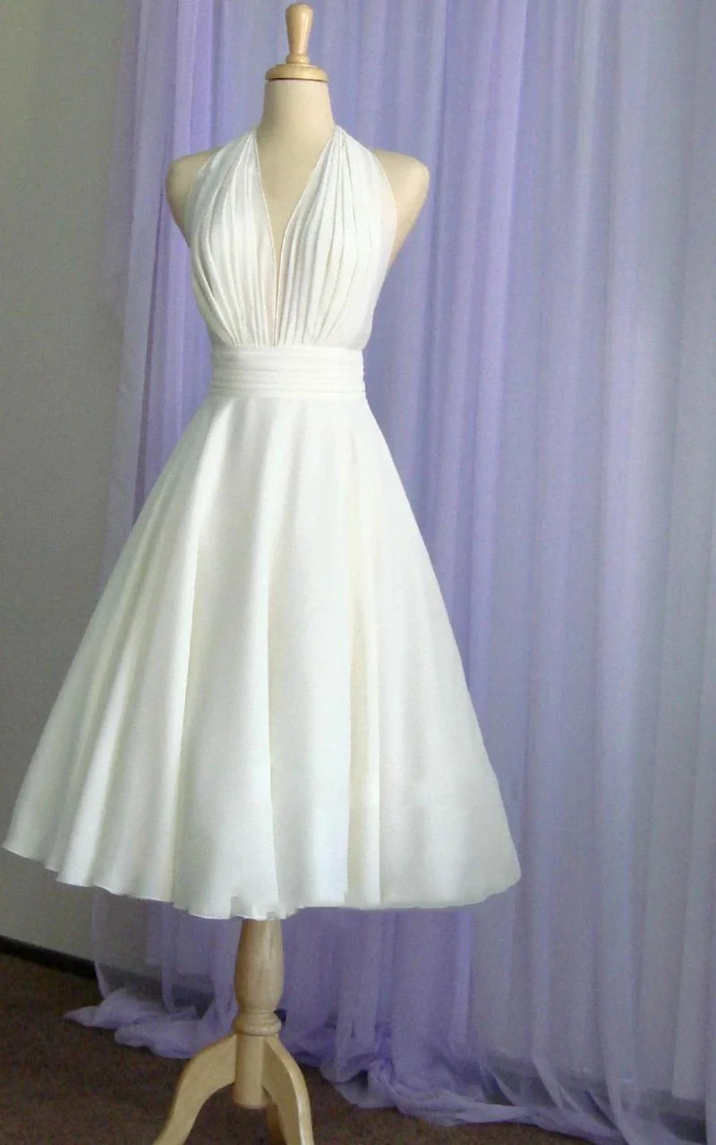 Close-up of the halter neck and bow detail on a chiffon wedding dress.