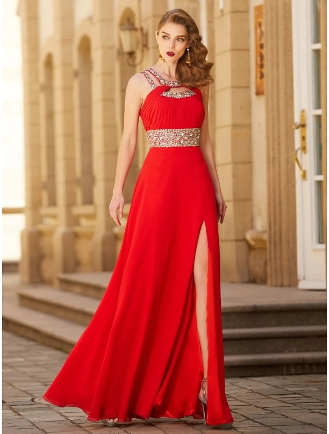 Model wearing an elegant A-Line halter neck chiffon evening gown with a rhinestone slit.