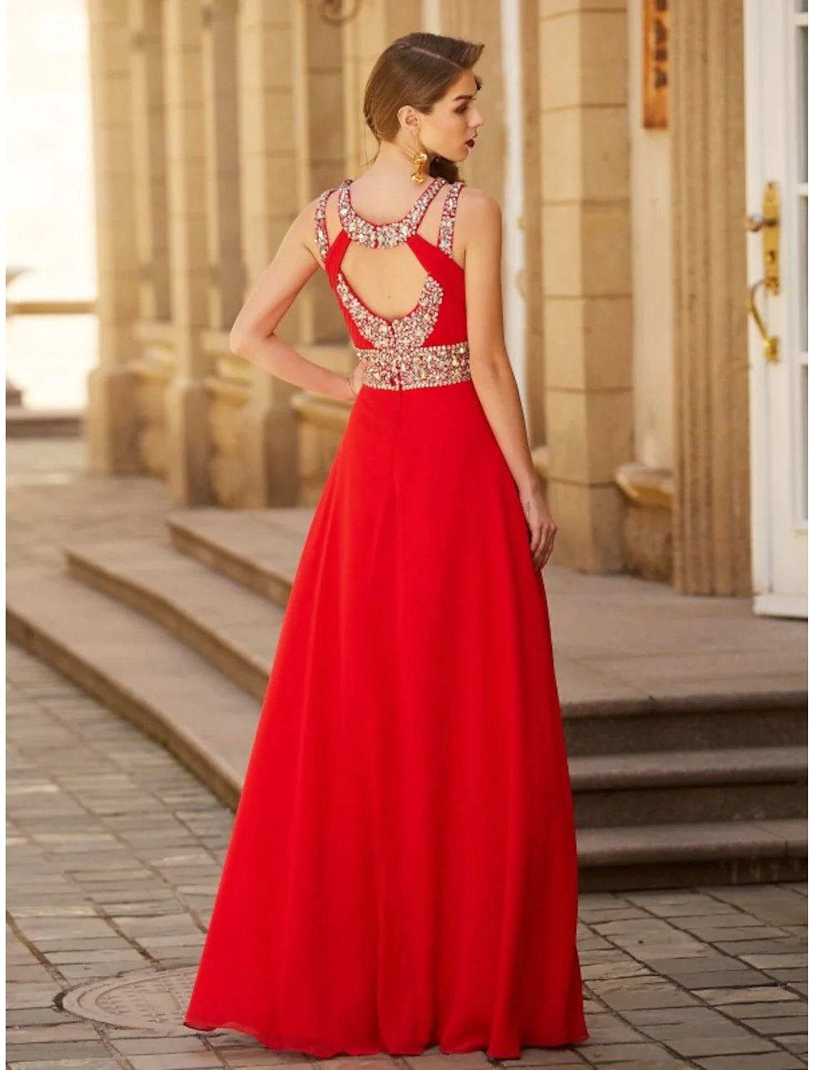 Close-up of the halter neckline and rhinestone embellishment on the chiffon gown.