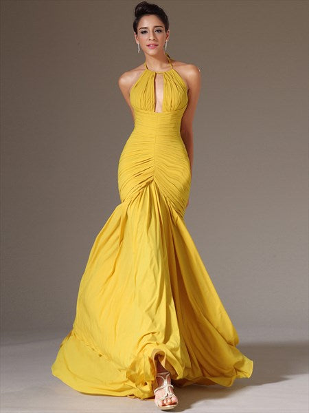 Model wearing a yellow halter neck keyhole prom dress.
